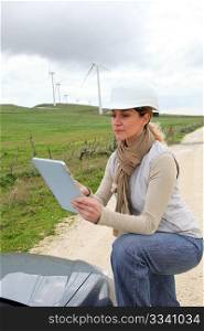 Engineer in wind turbines field using electronic tablet