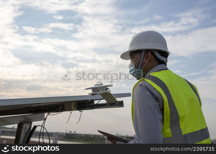 Engineer inspects pyranometer installation in solar farm to measure sunlight in solar power generation