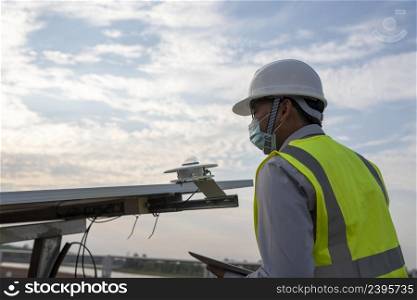 Engineer inspects pyranometer installation in solar farm to measure sunlight in solar power generation