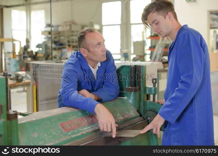 Engineer instructing apprentice