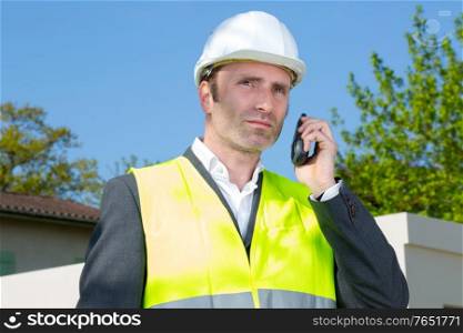 engineer is make call with a walkie talkie outdoors
