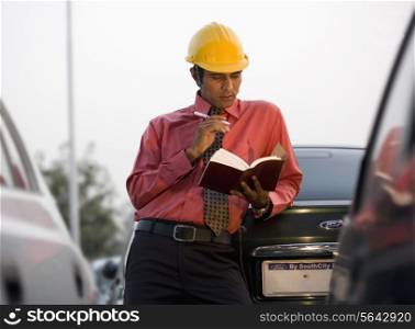 Engineer looking at a book