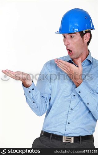 Engineer looking at his hand in amazement
