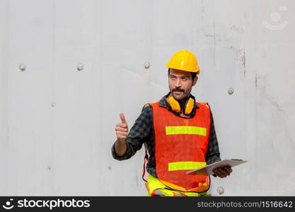 Engineer man holding clipboard checklist with giving thumbs up as sign of success