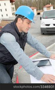 Engineer on construction site with electronic tab