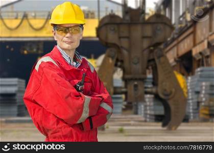 Engineer, posing in front of a steel mill