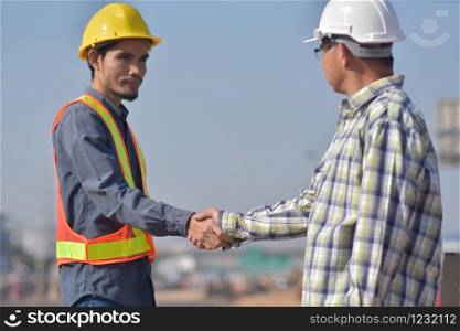Engineer shake hand Foreman at construction site