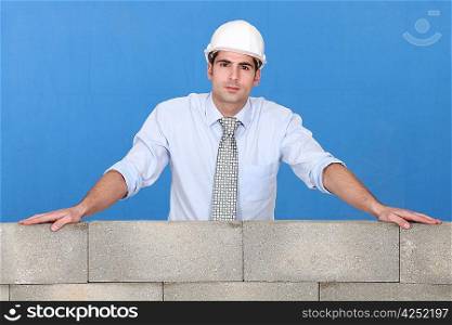 Engineer standing by a wall
