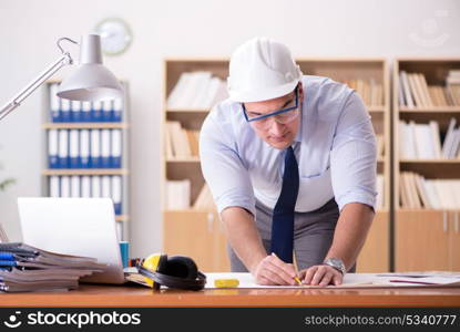 Engineer supervisor working on drawings in the office