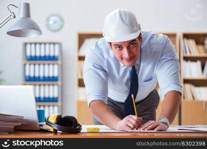 Engineer supervisor working on drawings in the office