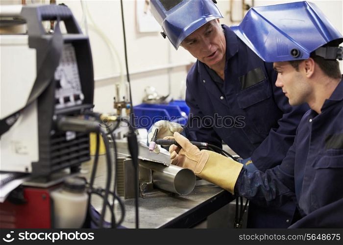 Engineer Teaching Apprentice To Use TIG Welding Machine
