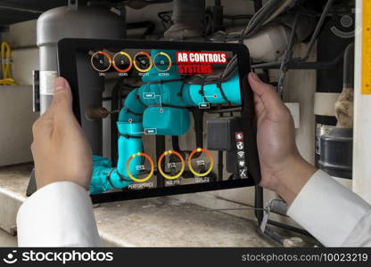 Engineer use augmented reality software in smart factory production line with automated application . Futuristic machinery in working in concept of Industry 4.0 or 4th industrial revolution.. Engineer use augmented reality software in smart factory production line