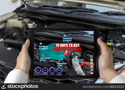Engineer use augmented reality software to monitor parts of car vehicle with automated application . Futuristic machinery in working in concept of Industry 4.0 or 4th industrial revolution.. Engineer use augmented reality software to monitor parts of car vehicle