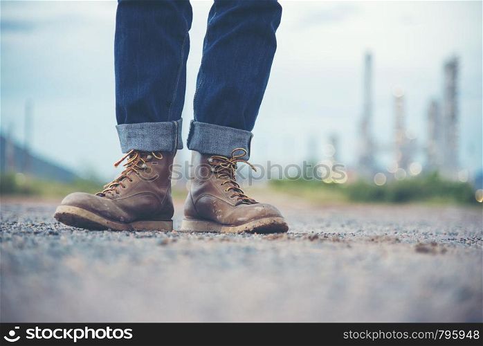 Engineer Wear Jeans And Brown Boots for Worker Security on Background of Refinery
