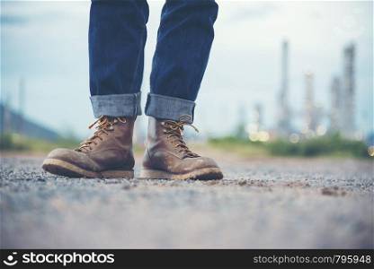 Engineer Wear Jeans And Brown Boots for Worker Security on Background of Refinery