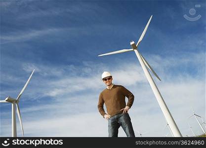 Engineer wearing hardhat at wind farm, portrait