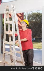 Engineer wearing helmet and eyegear and holding ladder