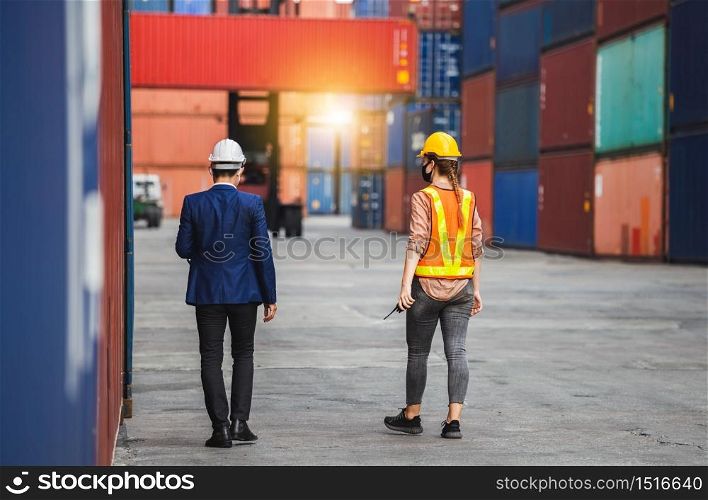 Engineer wearing protection face mask against coronavirus, Foreman worker team checking containers box from cargo