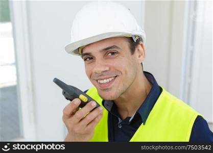 engineer with a walkie-talkie in his hand