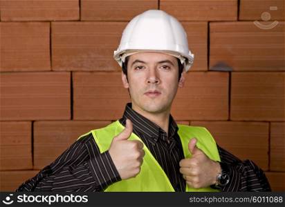 engineer with white hat and a brick wall as background