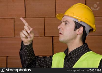 engineer with white hat and a brick wall as background