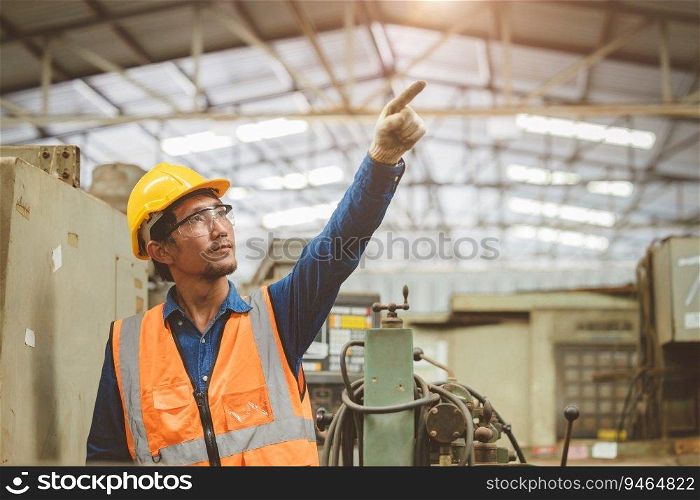 Engineer woker in factory hand rising. Asian staff pointing for future concept.