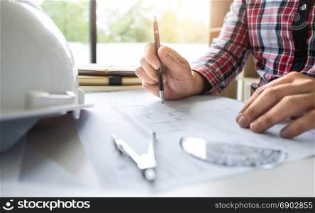 engineer woking on blueprint with tools - interior architect concept