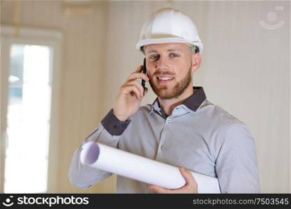 engineer working on outdoor project and talking on phone