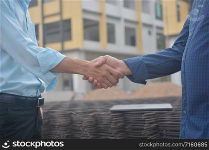 Engineering hands shake at work place building construction estate project success,Business people shake hand agreement investment business