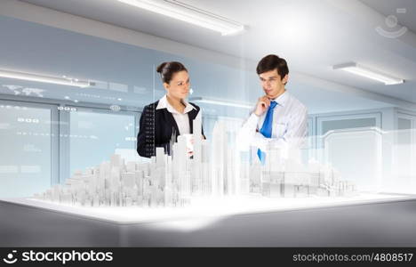 Engineering industry. Businessman and businesswoman discussing construction model of project