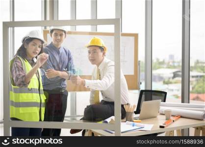 Engineering people are analytics construction plans with blueprint in office .. Engineering people are analytics construction plans with blueprint in office