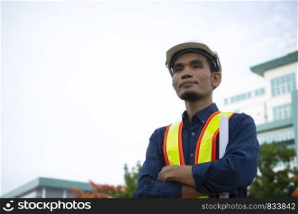 Engineering wears a white safety hat while working. Background building structure