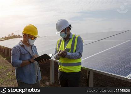 Engineers and technicians work on planning to power solar panel renewable power plants.