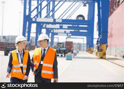 Engineers conversing while walking in shipping yard