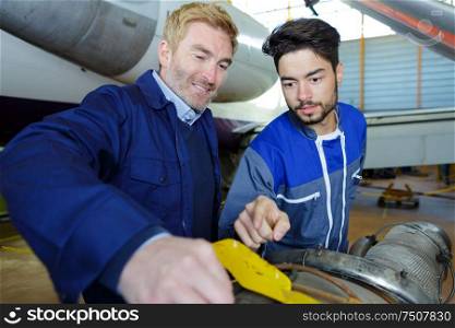 engineers fixing an aiplane enginee