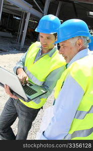 Engineers meeting on building site