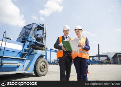 Engineers reading file in shipping yard