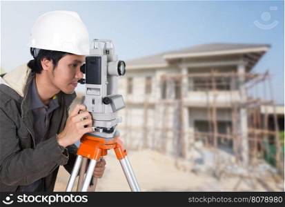 Engineers use tacheometer or theodolite with building construction site background