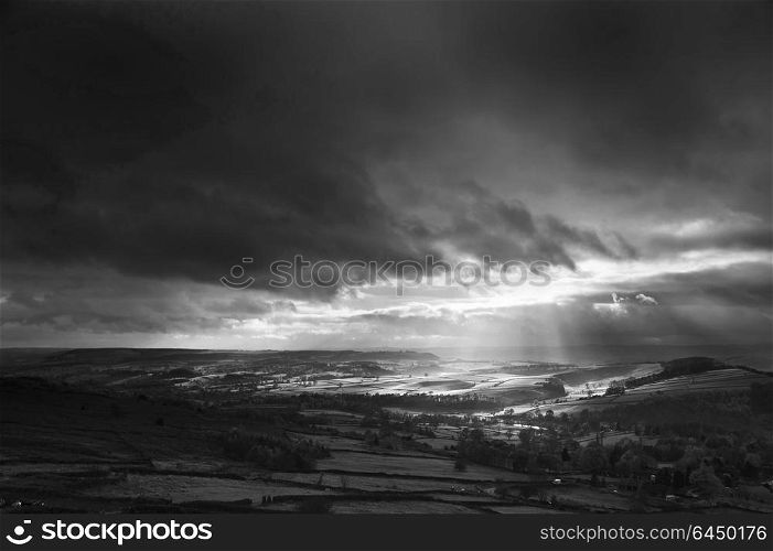 England, Derbyshire, Curbar Edge. Sunbeams over Big Moor in the Peak District in Autumn.. Stunning black and white sunbeams over Big Moor in the Peak District landscape in Autumn