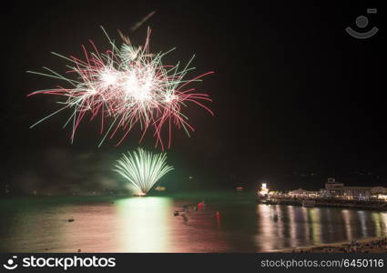 England, Dorset, Bournemouth. Firworks display over Bournemouth pier marking the end of Bournemouth Air Festival 2013.. Fireworks display over sea with pier and boats in water landscape scene