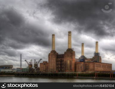England, London, Battersea. Battersea power station against dark a stormy sky.. Battersea power station against a dark stormy sky before local develoments changing the iconic skyline