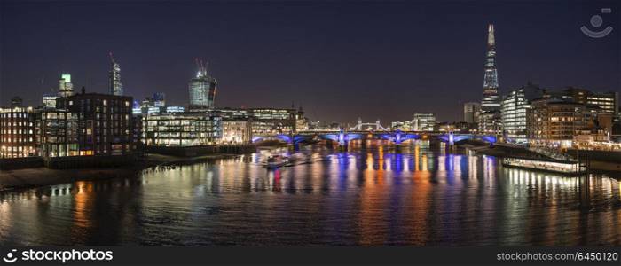 England, London, London Bridge. London night skyline of Shard with Tower Bridge and Walkie Talkie.. Stunning London City skyline landscape at night with glowing city lights and iconic landmark buldings and locations