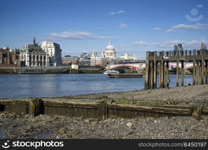 England, London, Southbank. Low tide on the River Thames.. Beautiful London city skyline landscape on blue sky Summer day