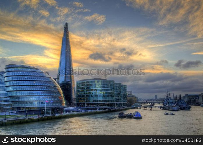 England, London, The Shard. View of The Shard with City Hall and HMS Belfast from Tower Bridge.. London cityscape landscape image during Winter sunset