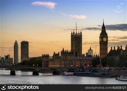 England, London, Westminster. Sunset skyline of Big Ben and Houses of Parliament in London.. Stunning London City skyline landscape at night with glowing city lights and iconic landmark buldings and locations