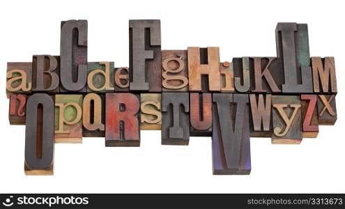 English alphabet abstract in antique wood letterpress printing blocks of different sizes and styles, isolated on white