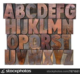 English alphabet in letterpress wood type printing blocks, stained by color inks