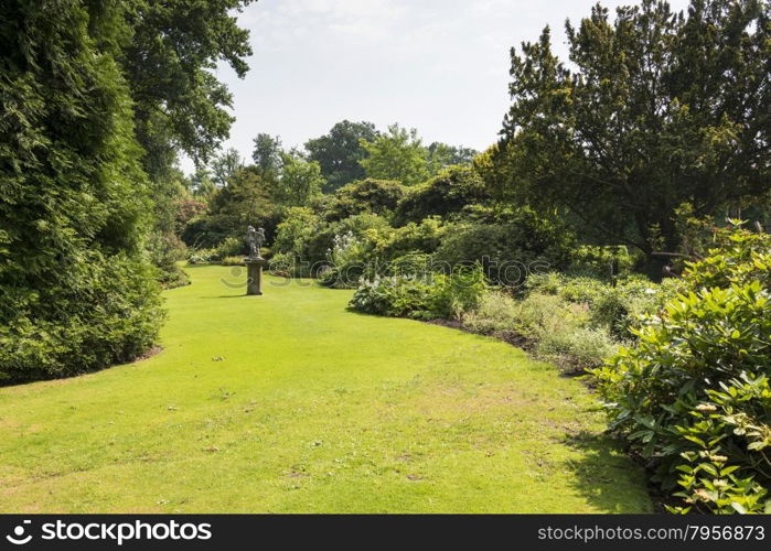 english border green grass garden with trees and plants