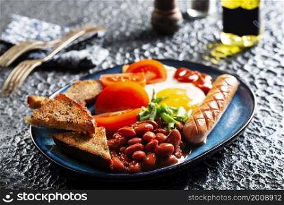English breakfast with sausage, eggs and beans