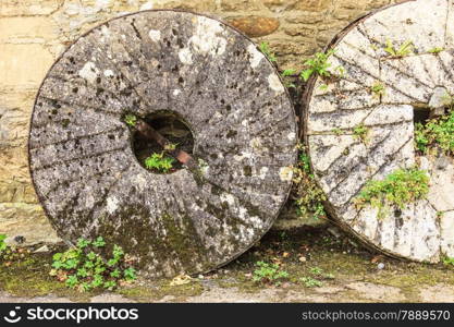 English cottage and old vintage coach stone wheels around house